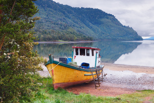 old boat anchored on the beach of the fjord of Puyuhuapi, Patago