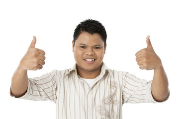 portrait of a boy showing thumbs up.