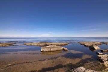 Ocean rocks and blue sky/Horizon over blue ocean