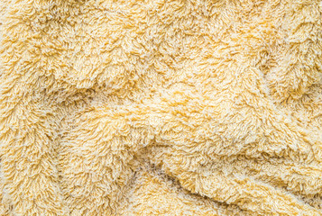 Closeup surface yellow wrinkled napkin fabric textured background