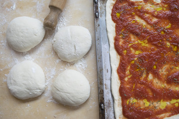 pastry board rolling pin and dough balls to make the pizza