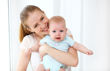 happy family mother playing  with baby