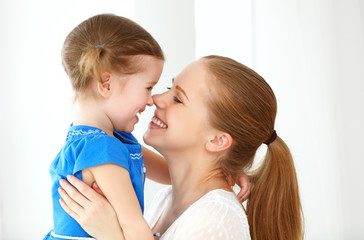 Obraz na płótnie Canvas Happy loving family. mother and child laughing and hugging