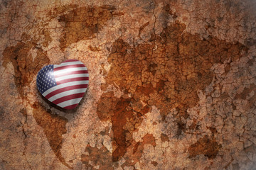 heart with national flag of united states of america on a vintage world map crack paper background. concept