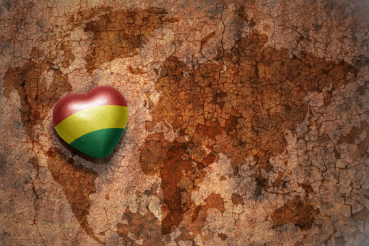 heart with national flag of bolivia on a vintage world map crack paper background. concept