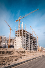 Industrial cranes and highrise building