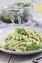 Pasta with pesto ,arugula and parmesan.Selective focus
