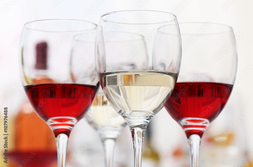 Poster wine glasses with red and white wine, closeup