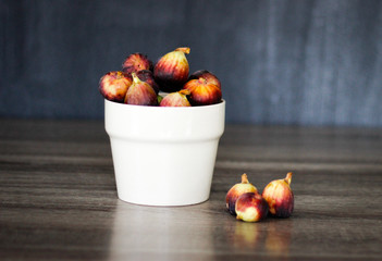 Colorful figs in a bowl with simple background