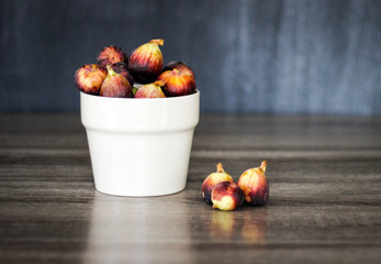 Colorful figs in a bowl with simple background