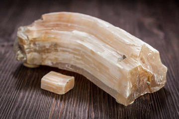 Gypsum - selenite on dark wooden background