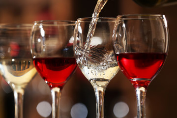 White wine pouring into wine glass, closeup