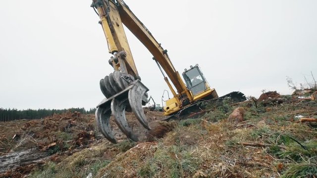 Excavator operating in a rock quarry. Hydraulic excavator works for formation of new lands