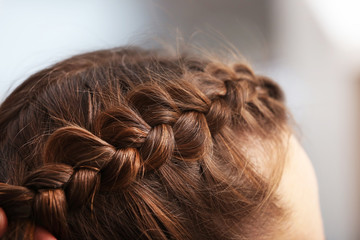 Fototapeta premium Professional hairdresser braiding clients hair