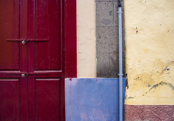 Colored wall with door and window.