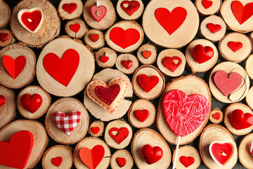 Valentine's Day concept. Different colourful hearts on wooden stumps background