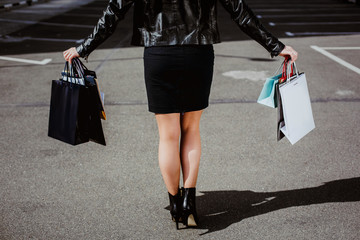 Closeup beautiful legs of  business woman carrying shopping bags
