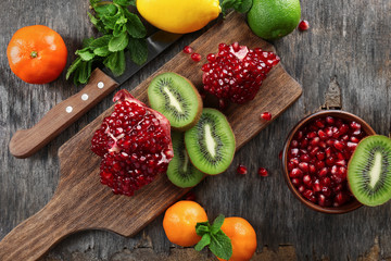 Juicy tropical fruits on wooden board, close up