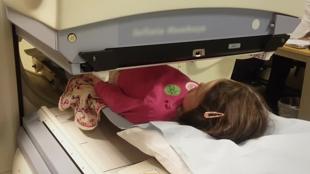 Child Having A Kidney Scan In Hospital With A Specialized Machine