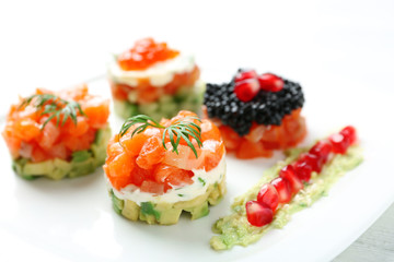 Delicious salmon tartare on white plate