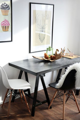 Modern room interior with table, chairs and pictures on the wall