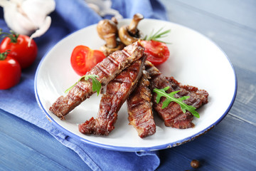 Grilled beef with vegetables on plate