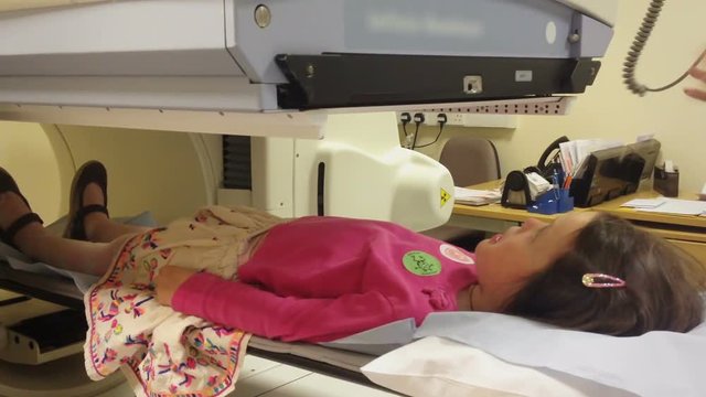 Child Having A Kidney Scan In Hospital With A Specialized Machine