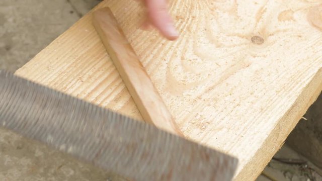 grinding of wooden plank using a rasp