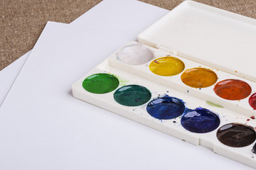 watercolor white palette and drawing paper on the table