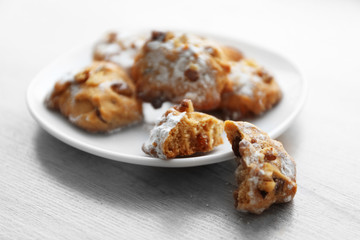 Plate of nut biscuits on wooden background, closeup