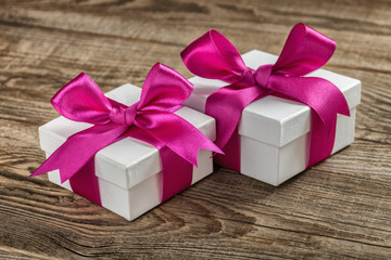 gift boxes with violet bow on wood board