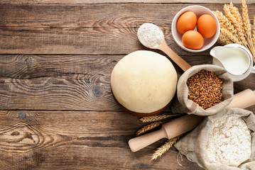 Easter concept. Wheat dough and ingredients for cooking on board.