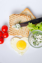 Breakfast sandwich with salad and scrambled eggs