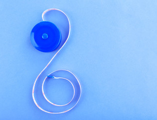 White measuring tape on a purple background