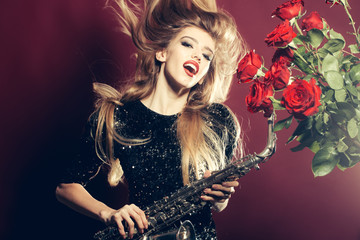 Fototapeta na wymiar Woman with sax and roses