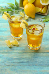 Glasses of ice lemon tea on wooden table