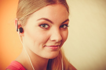 Woman with earphones listening to music. Leisure.