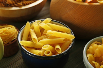 Various types of pasta in dishes, closeup