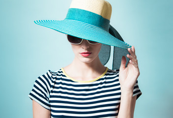 Hight fashion concept.  Female model portrait wearing hat and sunglasses. 