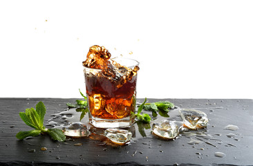 Glass of cola drink with ice and mint leaves