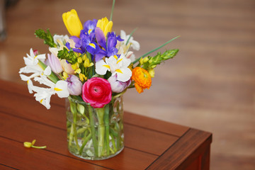 A bouquet of fresh flowers on wooden table, close up