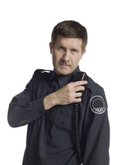 serious police officer holding a radio