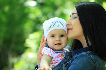 Mother kissing and holding daughter