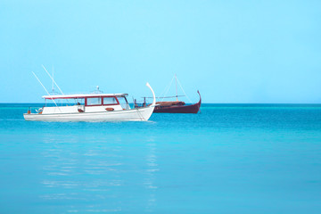 Fototapeta premium Boats in blue ocean. Summer vacation concept.