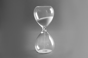 Sand hourglass on grey background