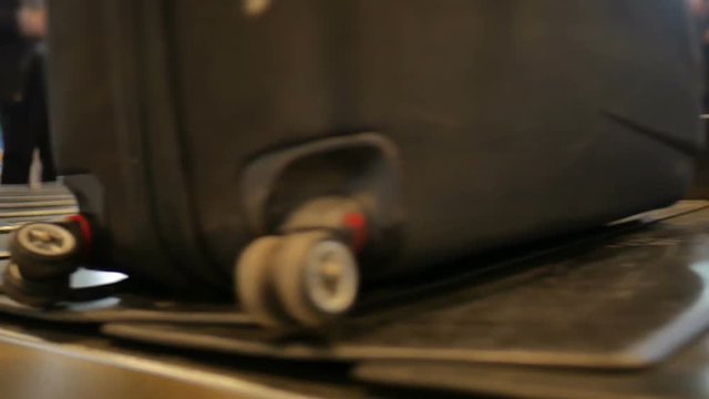 Airport baggage claim with luggage spinning around conveyor 
