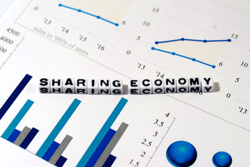 Colorful charts and SHARING ECONOMY on white cube