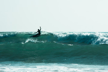 Surfer Whipping Into Action at a Waves Peak