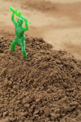 toy soldier in soil