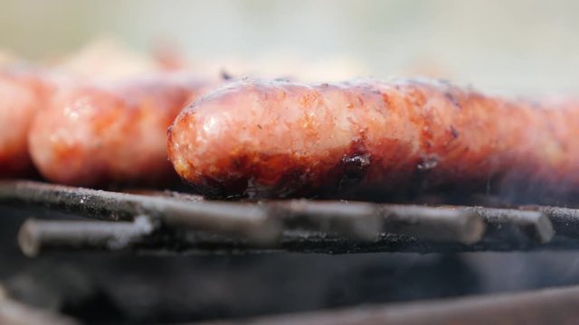 Smoke spreading over sausages on the barbecue 4K 2160p 30fps UltraHD footage - Mouthwatering juicy sausages on bbq smoke grilling 4K 3840X2160 UHD video